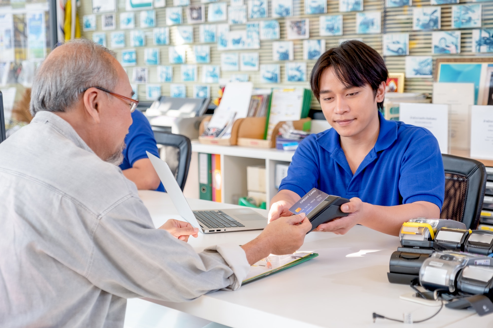 Customer service Asian worker or staff at office counter area receive credit card